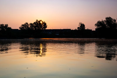 Scenic view of lake against orange sky