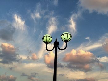 Low angle view of street light against cloudy sky