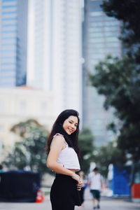 Portrait of woman standing in city