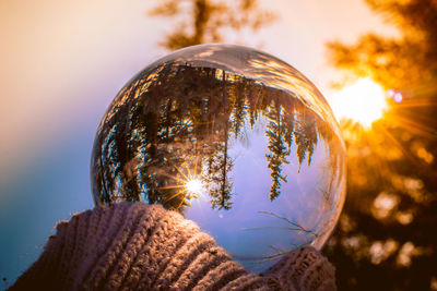 Low angle view of crystal ball against sky during sunset