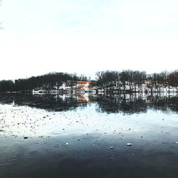 Scenic view of lake by building against clear sky