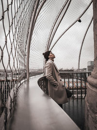 Man sitting on footbridge