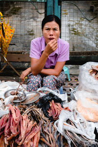 Woman holding fish at market