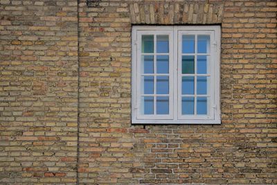 Full frame shot of window on brick wall of building