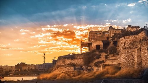 Buildings against sky during sunset