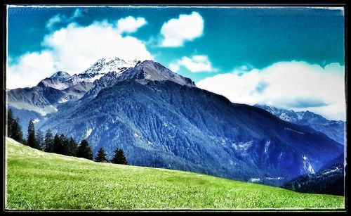 Scenic view of mountains against cloudy sky