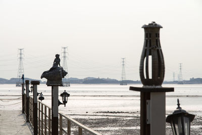 View of foot way over sea against clear sky