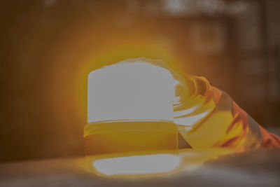 Close-up of yellow bottle on table