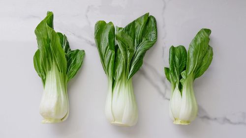 Close-up of green leaves fresh bok choy on the table directly above shot 