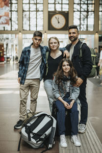 Portrait of smiling family standing together at station