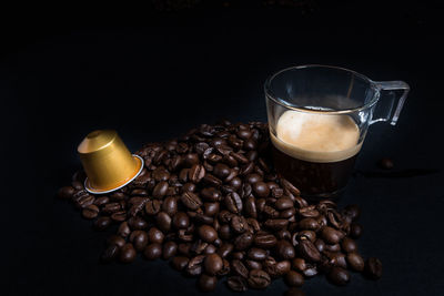 Coffee cup on table against black background