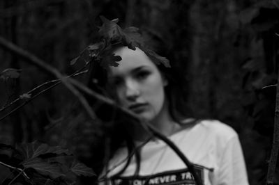 Close-up portrait of young woman with flowers