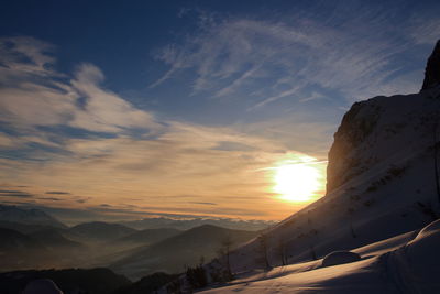View of snow covered landscape during sunset