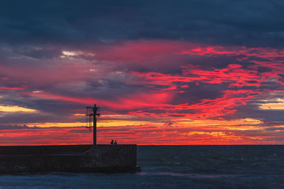 Scenic view of dramatic sky over sea during sunset