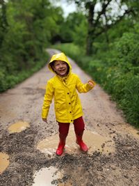 Portrait of boy standing on road