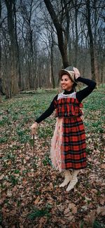 Happy woman with sword stands in the forest