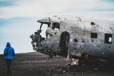 Low angle view of abandoned airplane on airport runway against sky