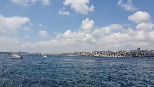 Scenic view of sea against sky in city