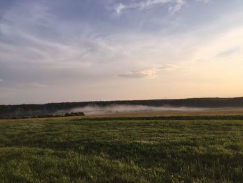 Scenic view of field against sky during sunset