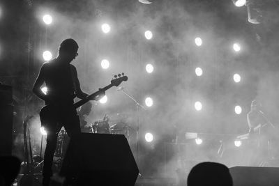 Man playing bass at music concert