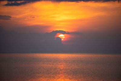 Scenic view of sea against orange sky