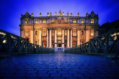 Statue in city at night