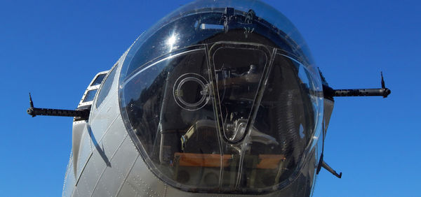 Low angle view of airplane against clear blue sky