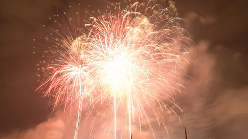 Low angle view of firework display at night