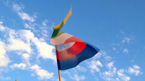 Low angle view of flag against blue sky