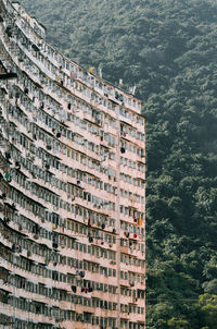 High angle view of building by trees in city