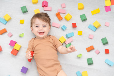 High angle view of boy playing with toys on table