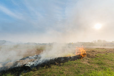 Fire on field against sky