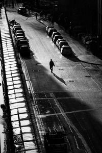 High angle view of man walking on footpath