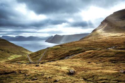 Scenic view of mountains against cloudy sky