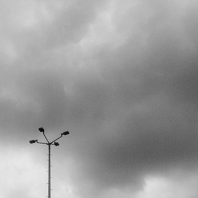 low angle view, sky, street light, cloud - sky, lighting equipment, cloudy, silhouette, overcast, cloud, electricity, weather, power line, pole, dusk, nature, high section, outdoors, no people, cable, day