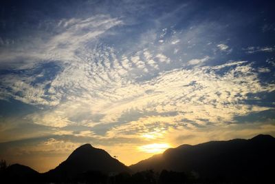 Scenic view of silhouette mountains against sky during sunset