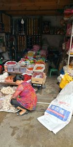 Woman for sale at market stall