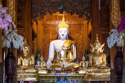 Statue of buddha statues in temple outside building