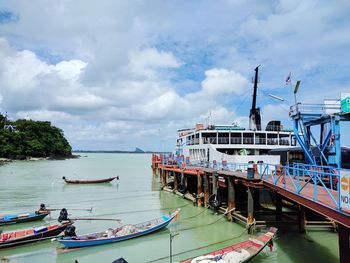 Boats moored on sea against sky