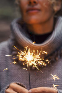 Close-up of woman holding sparkler