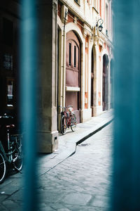 Bicycle on street amidst buildings in city