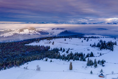 Scenic view of snow covered mountains against sky