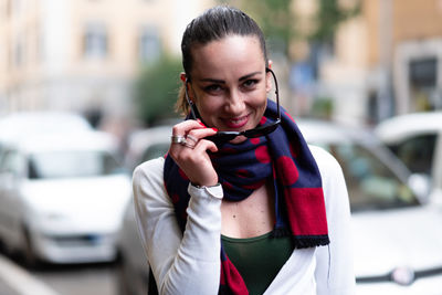 Portrait of smiling young woman standing outdoors