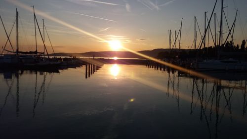 Sailboats in marina at sunset