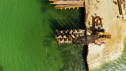 Pile driver hammer in action. construction bridge over the sea bay on the tropical island of siargao