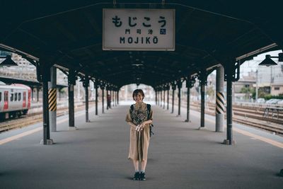 Portrait of young man at railroad station