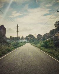 Empty road along trees