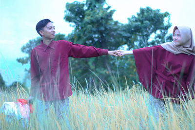 Smiling young couple with plants