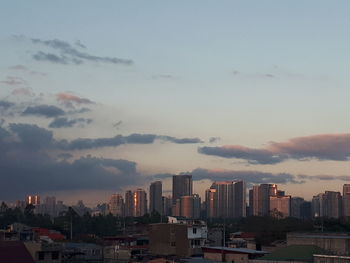 Aerial view of buildings in city against sky during sunset
