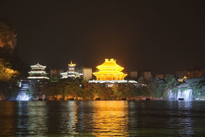 Illuminated buildings at waterfront